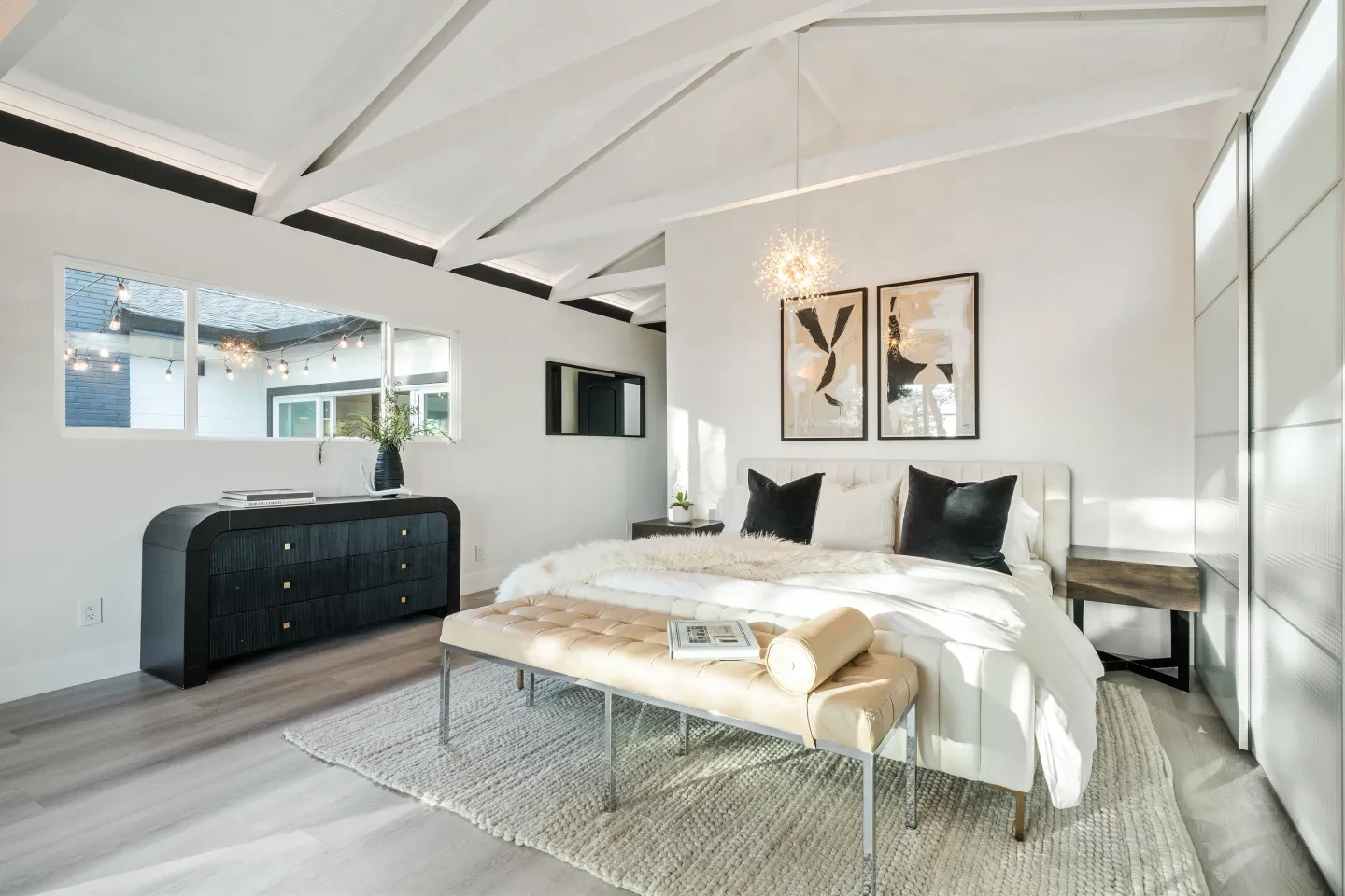 Modern bedroom with dark herringbone headboard and concrete floors