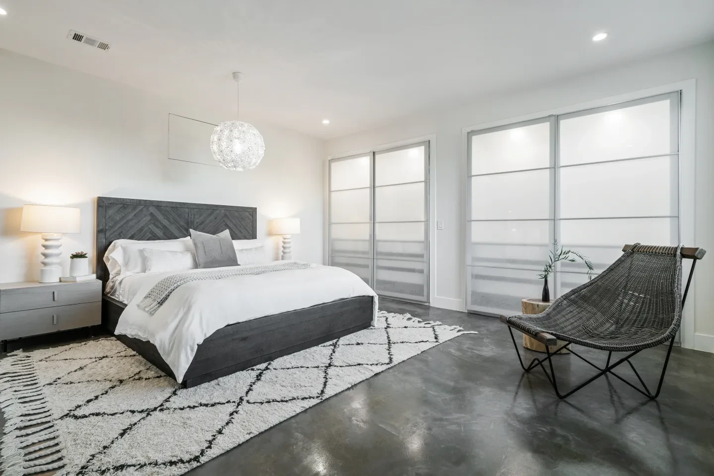Bright master bedroom with vaulted ceilings and tufted bench