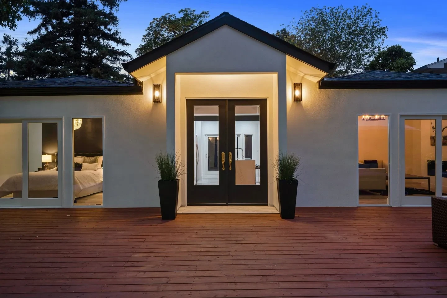 Modern home exterior at dusk with warm lighting