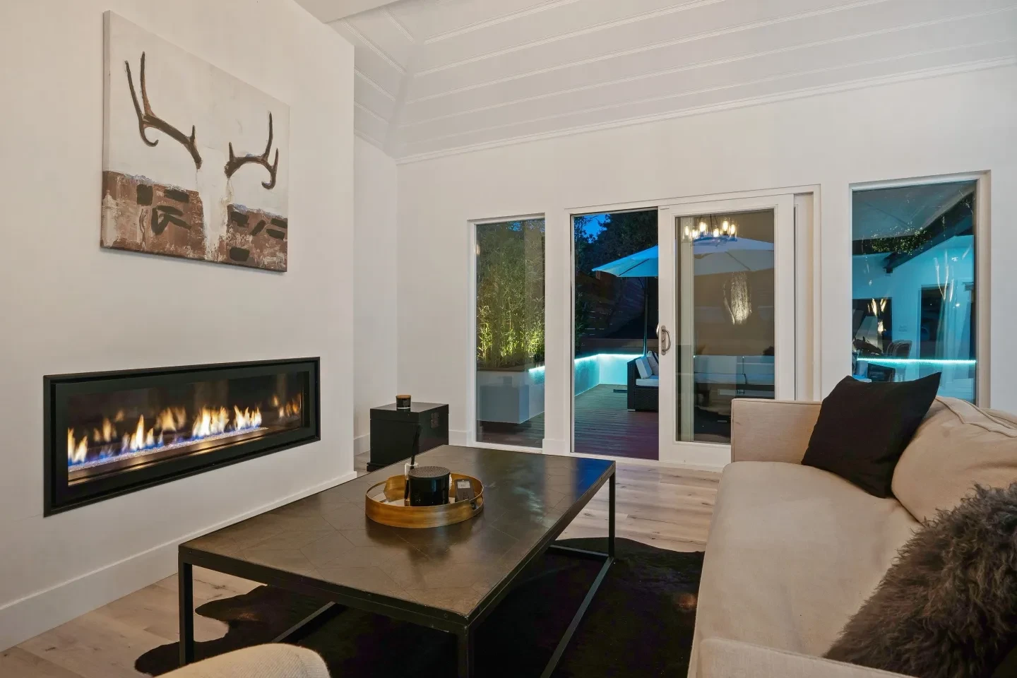 Modern living room with fireplace and outdoor views at night