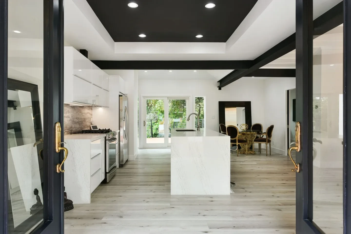 Modern kitchen and dining space with black and white color scheme