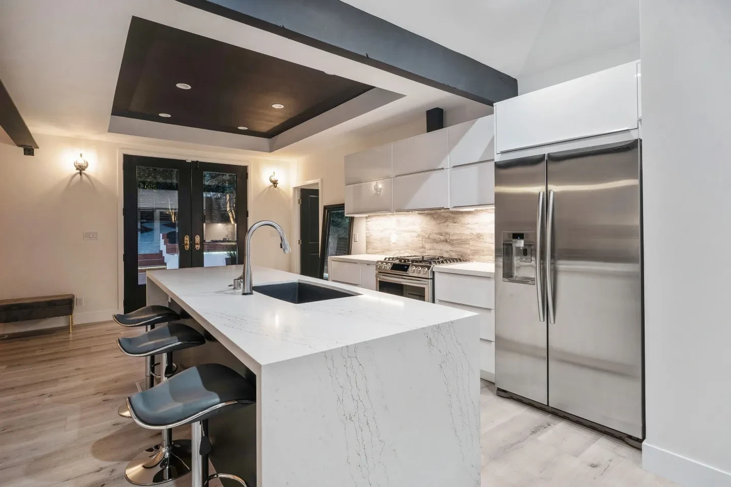 Modern kitchen with white cabinetry and two-tone ceiling