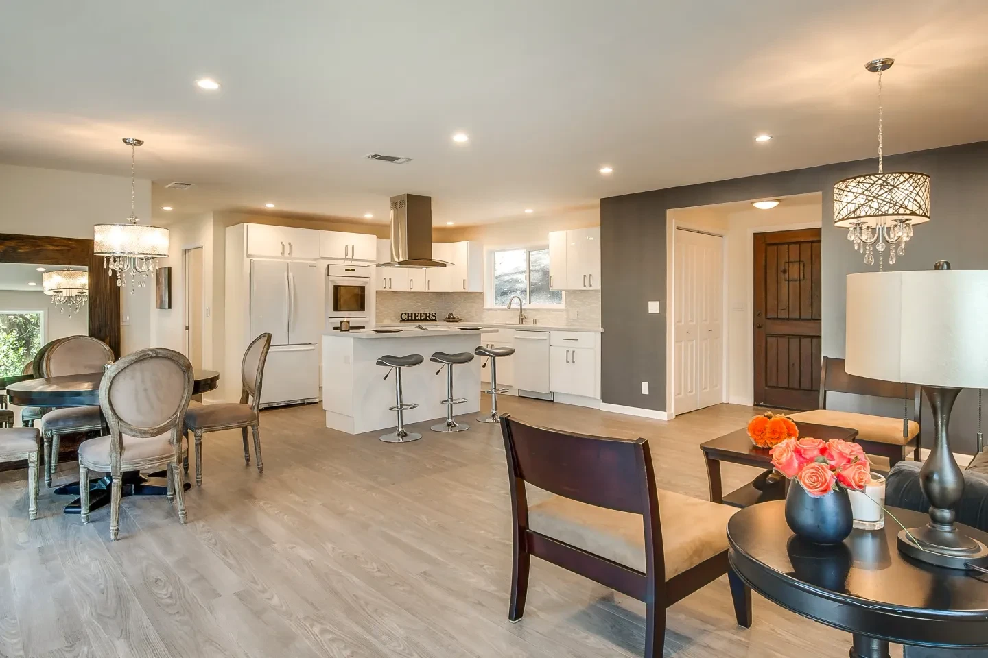 Modern open concept kitchen and dining area with warm lighting