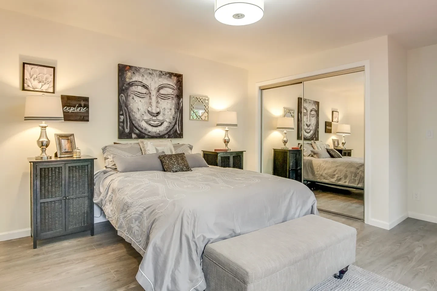 Serene bedroom with neutral tones and Asian-inspired artwork