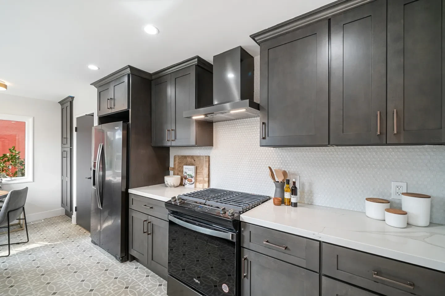 Modern kitchen with dark cabinetry and white quartz countertops
