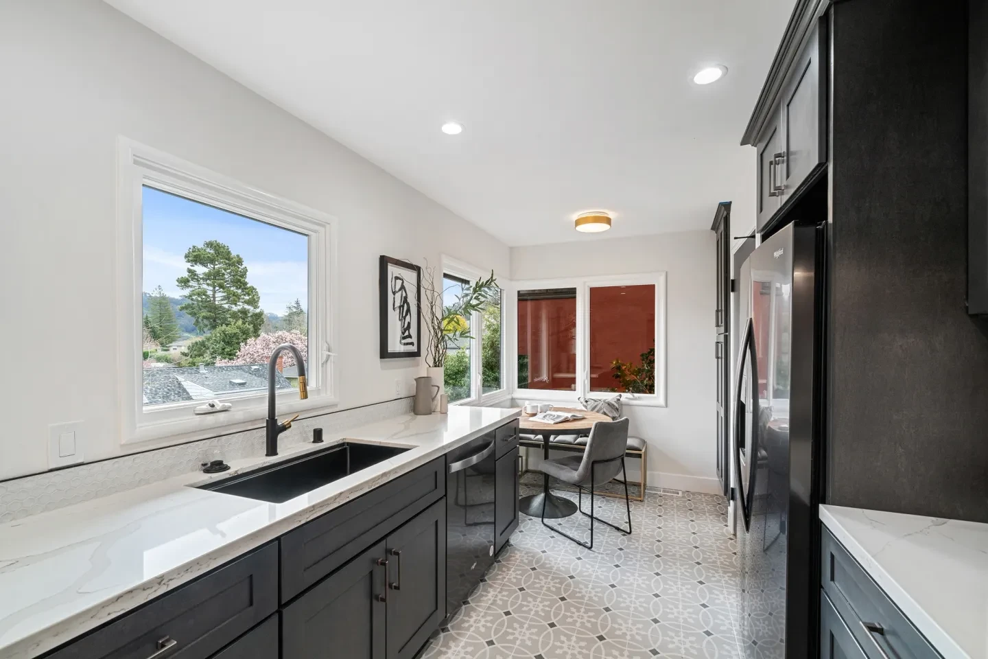 Modern kitchen with dark cabinetry and scenic window views